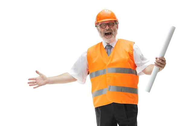 Free photo the happy builder in a construction vest and an orange helmet smiling at studio. safety specialist, engineer, industry, architecture, manager, occupation, businessman, job concept