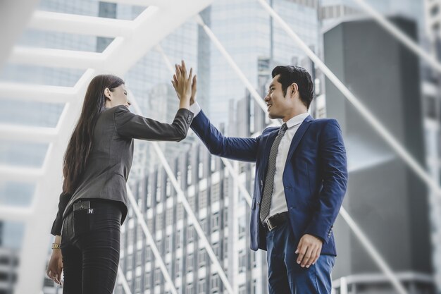 Happy business colleague success with business giving hi-five.