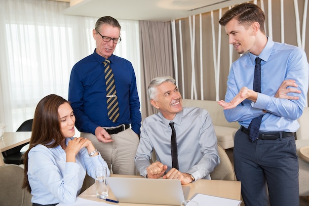 Happy Business People Discussing Project in Cafe