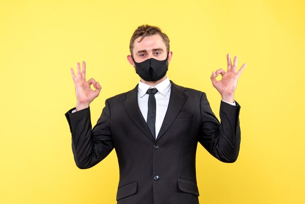 Free Photo happy businessman make double ok hand sign on yelow