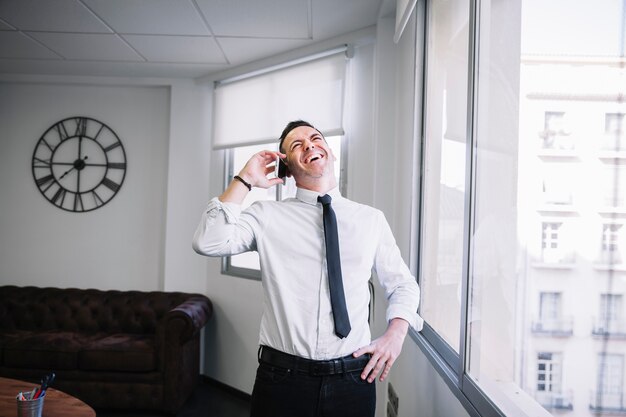 Happy businessman on phone