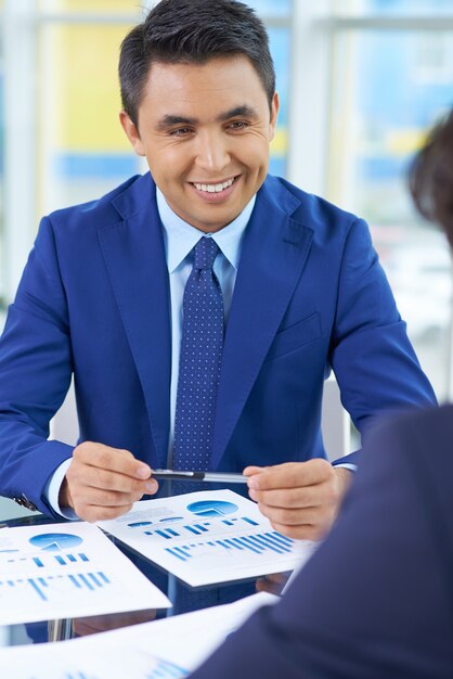 Happy businessman with diagrams