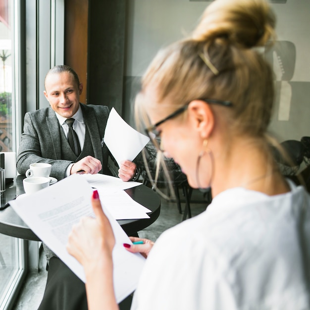 Free photo happy businessman with his partner working on document in caf�