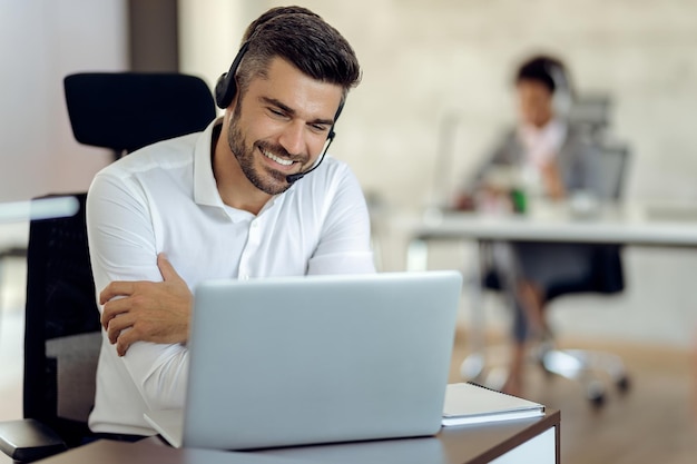 Happy businessman working on a computer in the office