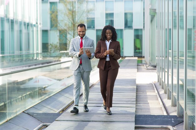 Happy businesspeople using gadgets