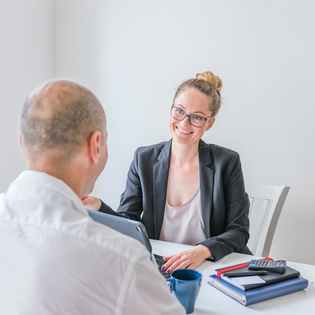 Happy businesswoman looking at her partner in office