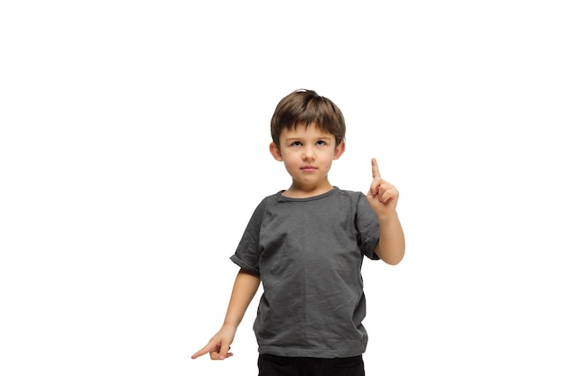 Free photo happy caucasian little boy isolated on white studio background looks happy cheerful sincere copyspace childhood education emotions concept