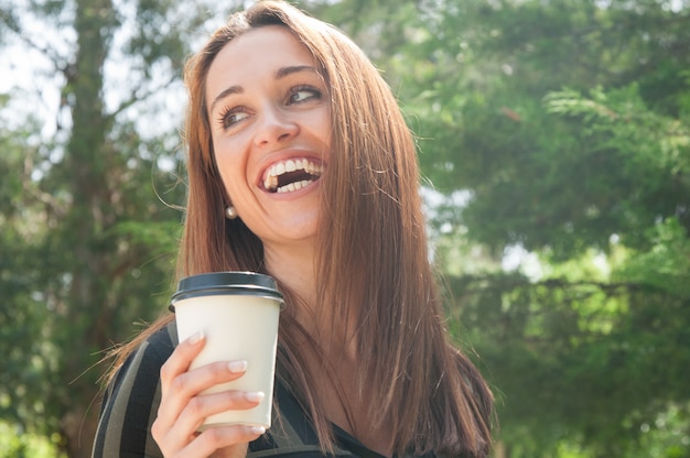 Happy cheerful girl walking in park