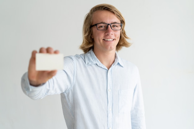 Free Photo happy cheerful young leader showing business card