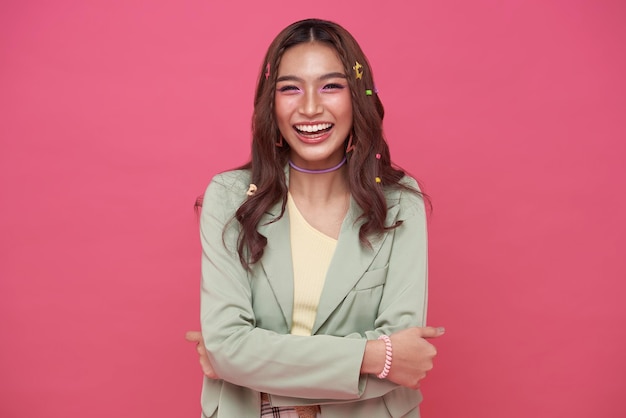 Happy cheerful young woman laugh looking at camera with joyful and charming smile isolated on pink