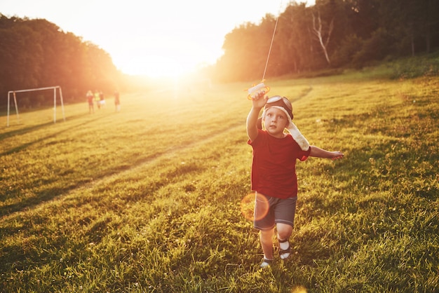 Free Photo happy child launch a kite in the field at sunset. little boy and girl on summer vacation