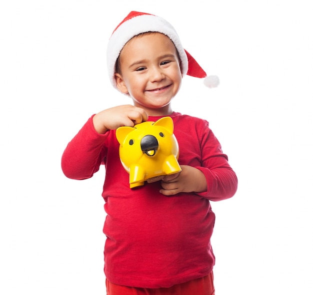 Happy child with his piggybank