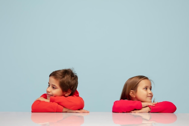 Free Photo happy children isolated on blue studio background look happy cheerful sincere copyspace childhood education emotions concept