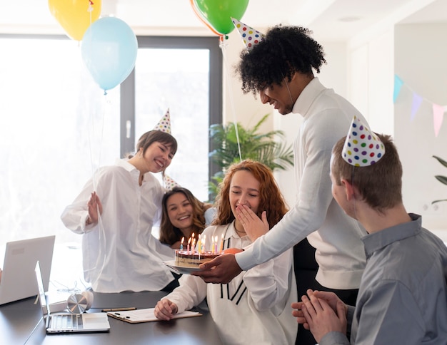 Free Photo happy colleagues celebrating at work medium shot