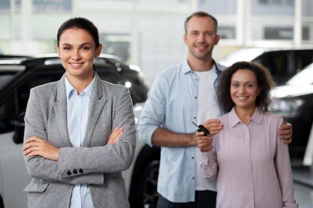 Happy couple in car showroom dealership