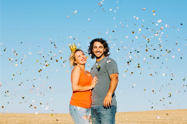 Happy couple under confetti shower