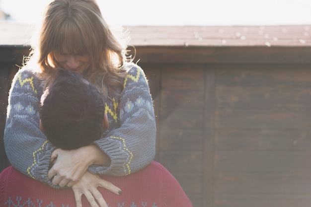 Free photo happy couple cuddling outdoors