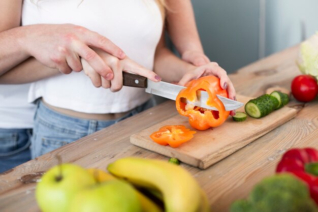 Happy couple cutting the bell pepper