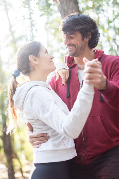 Happy couple dancing in the forest