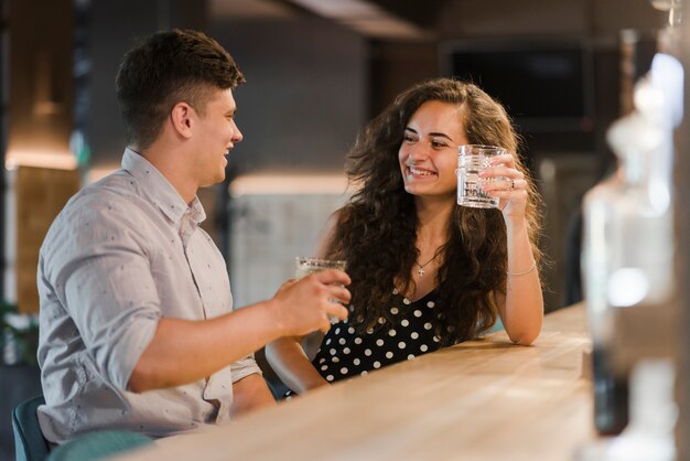 Happy couple enjoying drinks in bar