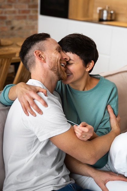 Happy couple finding out they're going to be parents based on pregnancy test