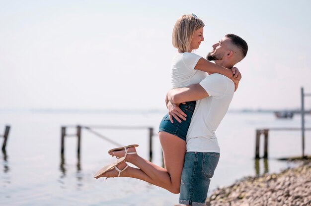 Happy couple hanging out together on the beach