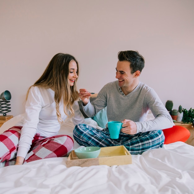 Free photo happy couple having breakfast in bed