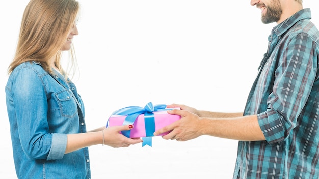 Free photo happy couple holding gift box on white background