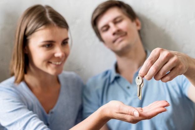 Free photo happy couple holding keys to old property