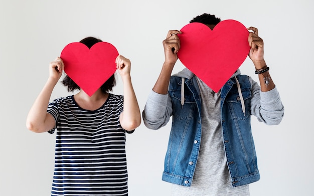 Free Photo happy couple holding red heart icons