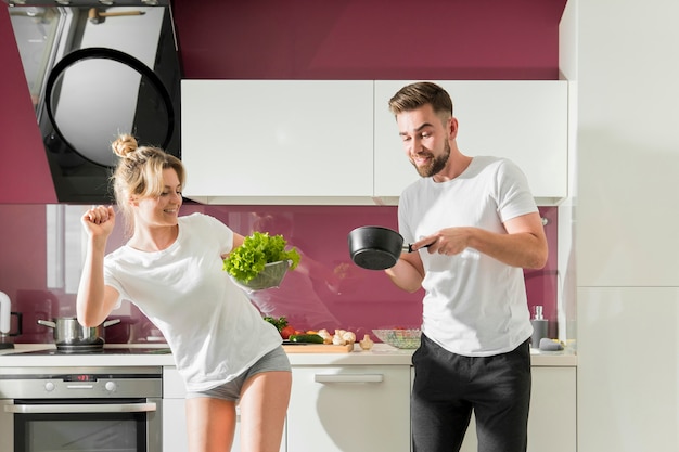 Free Photo happy couple indoors cooking