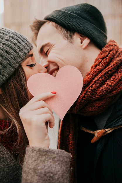 Free photo happy couple kissing on street