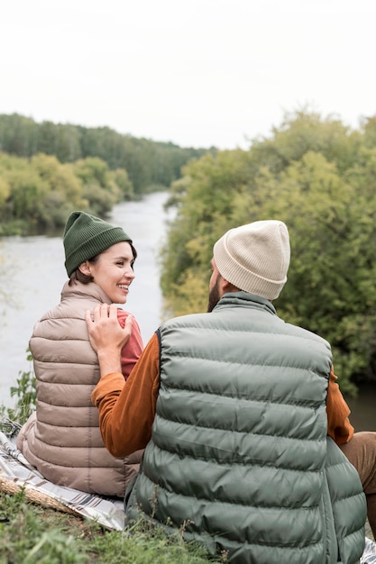 Happy couple looking at eachother near river