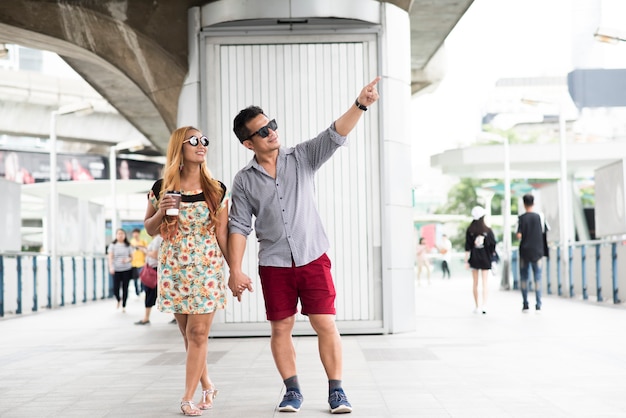 Free Photo happy couple in love walking in street 