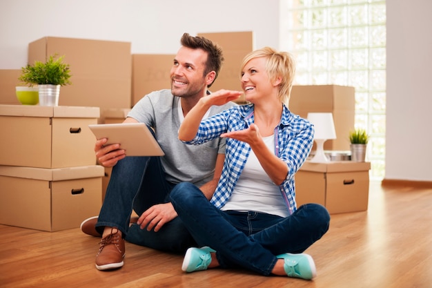 Happy couple planning decor in new home