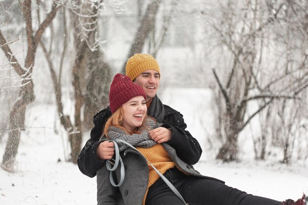 Happy couple playing outdoors in the snow