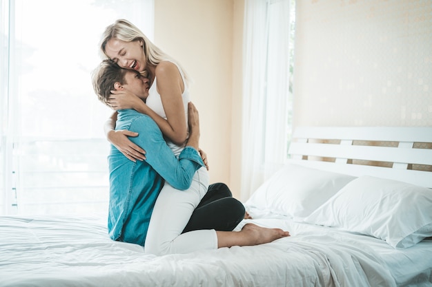 Happy Couple Playing together in the bedroom