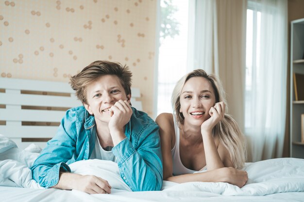 Happy Couple Playing together in the bedroom