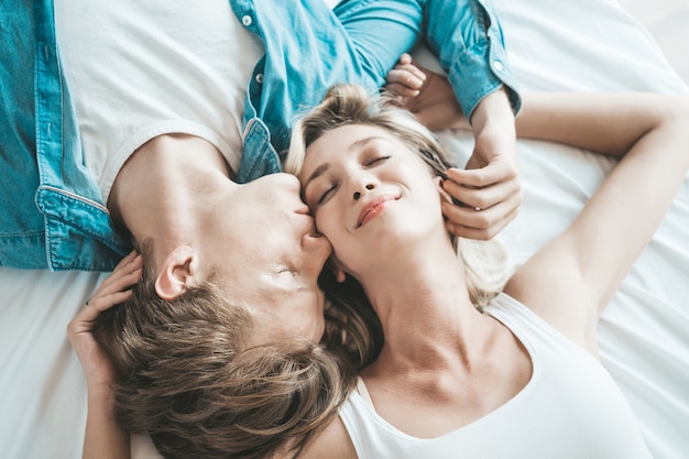 Happy Couple Playing together in the bedroom