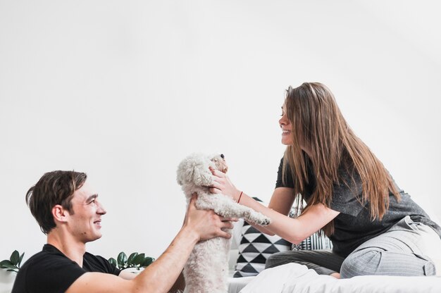 Happy couple playing with their dog