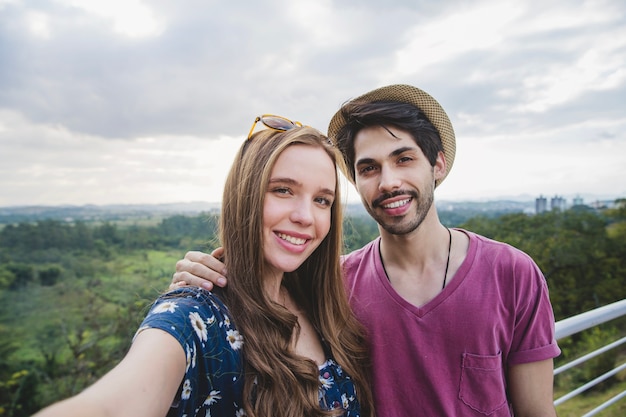 Happy couple selfie on viewing platform