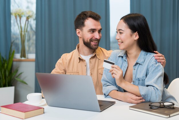 Happy couple shopping online while at desk