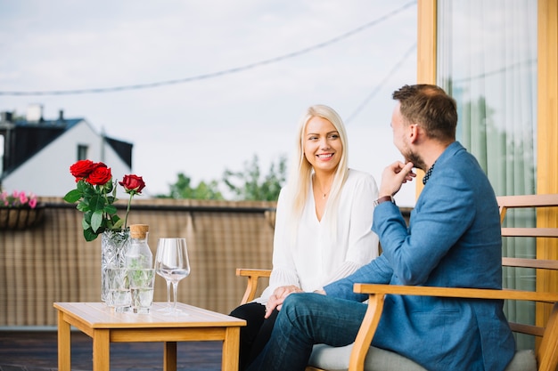 Free Photo happy couple sitting at rooftop