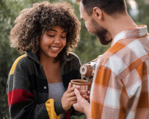 Happy couple spending time together outdoors camping