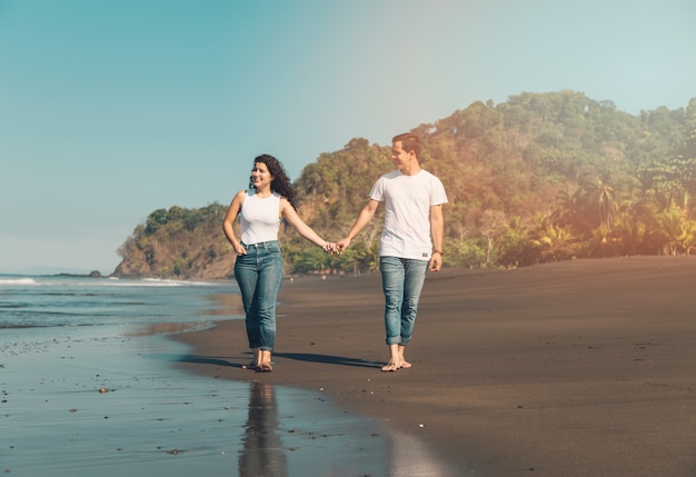 Happy couple strolling along seaside