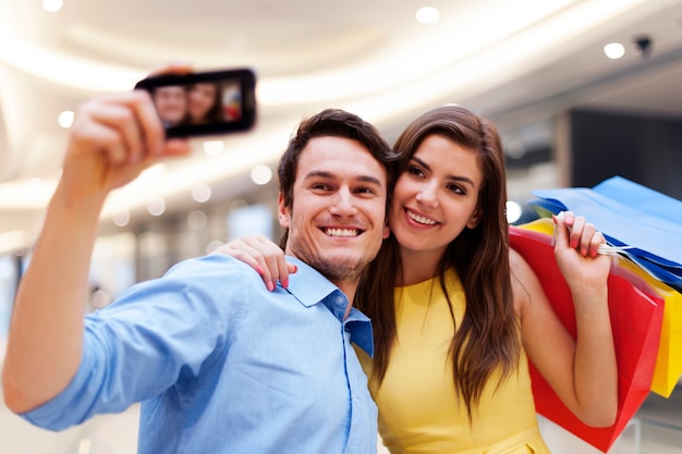 Happy couple taking a photo during a shopping