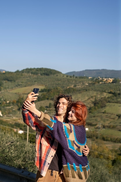 Free Photo happy couple taking selfie medium shot