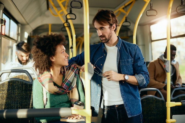 Free Photo happy couple talking to each other while commuting by bus