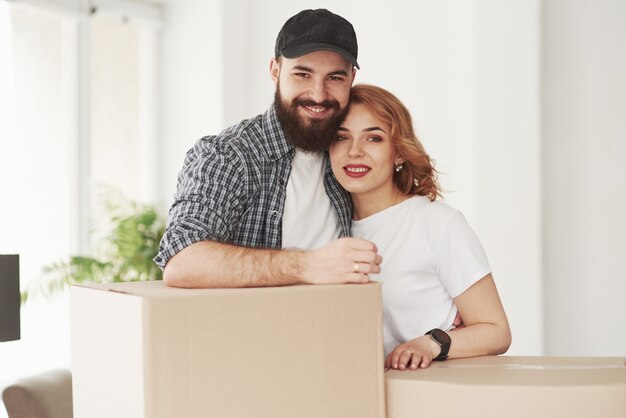 Happy couple together in their new house. Conception of moving