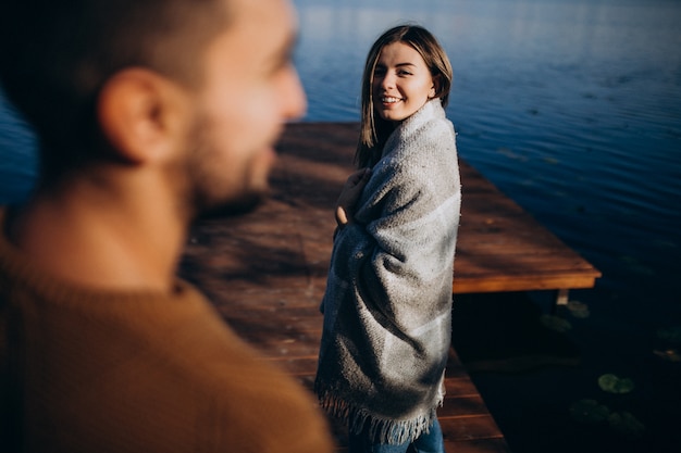 Free Photo happy couple with blanket by the river